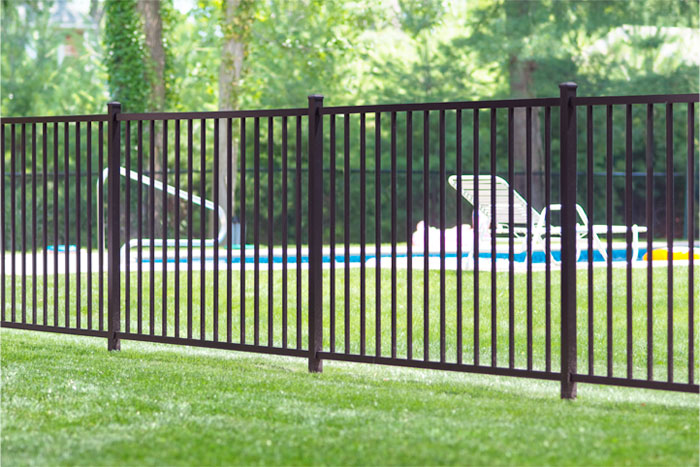 Black aluminum 2 rail fence near a pool