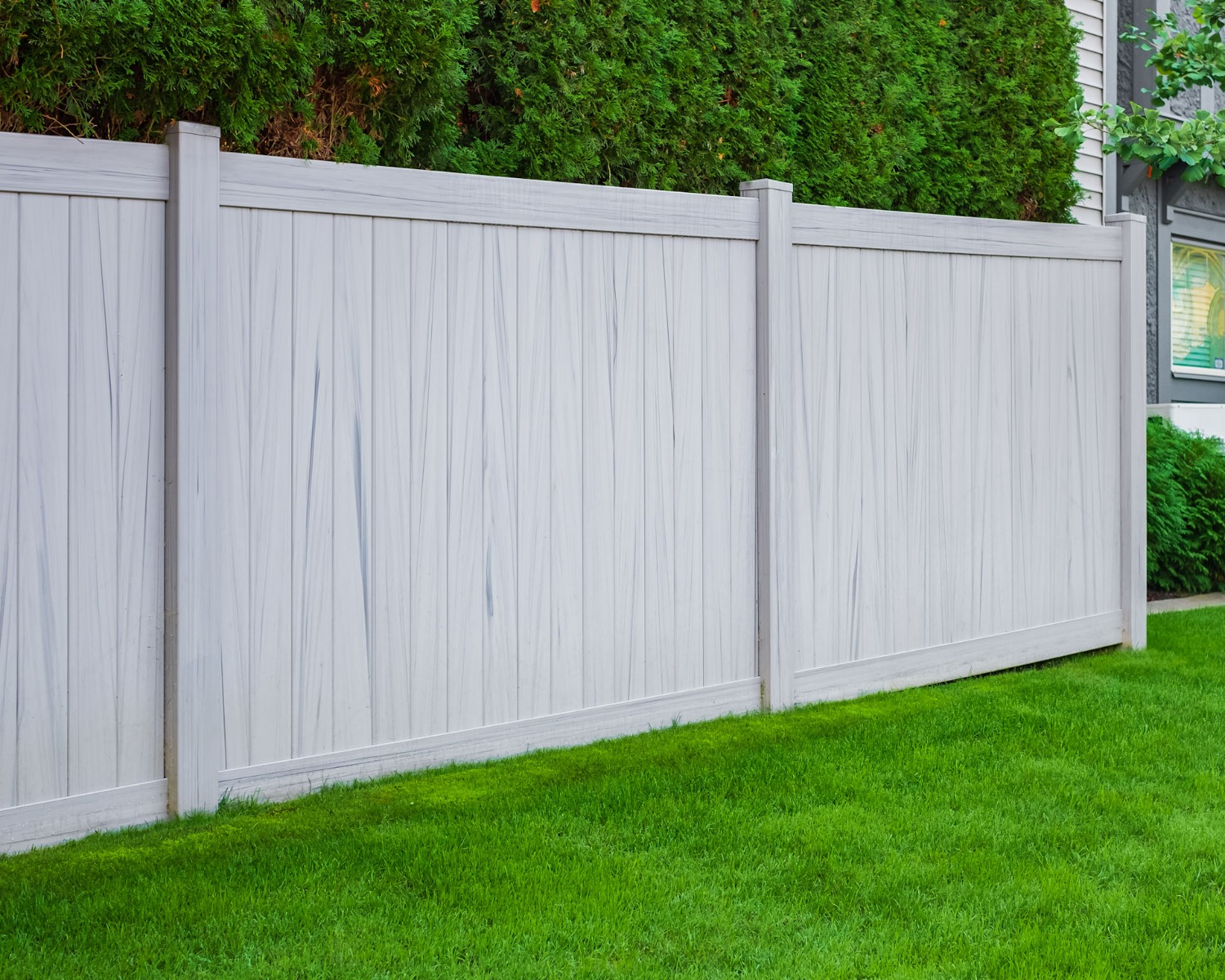 Grey wood grain vinyl privacy fence